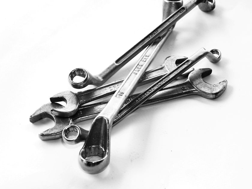 Industrial hand tools and power tools laid out on a workshop bench, representing wholesale hardware sourcing in the UAE and GCC