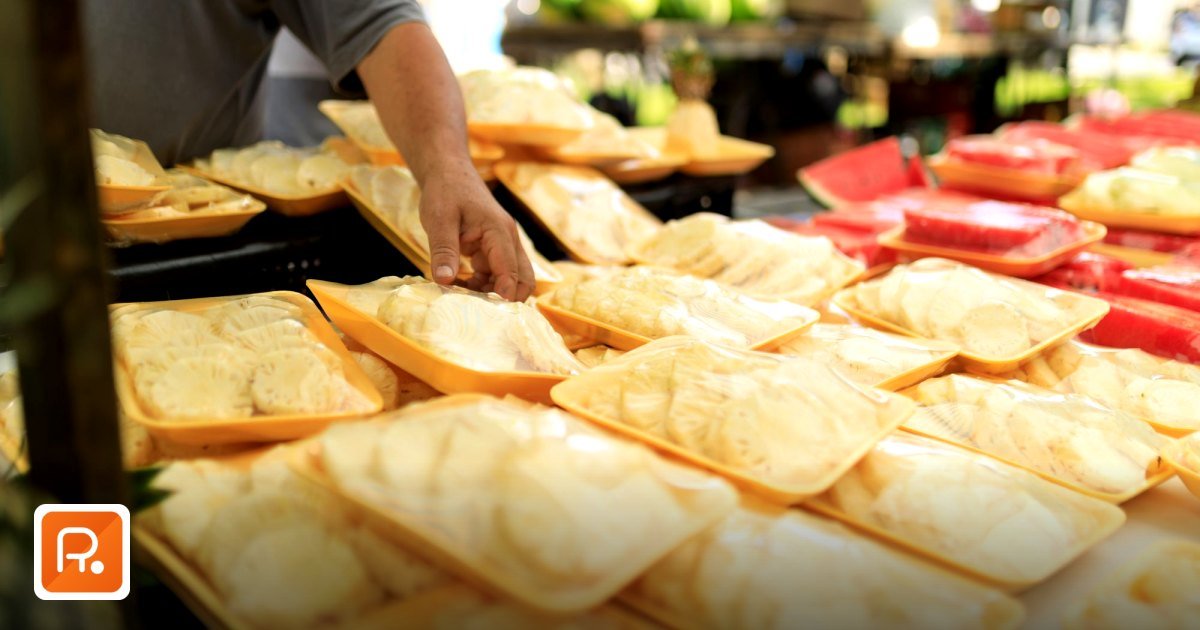 Best B2B Procurement Platforms in the UAE & GCC (2026 Buyer's Guide) - a person picking fresh packaged food at an outdoor