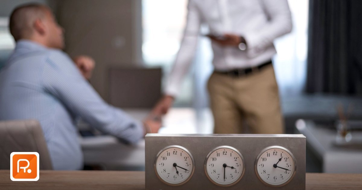 How to Reduce Procurement Cycle Time with a Saudi B2B Marketplace - two businessmen in an office with clocks showing