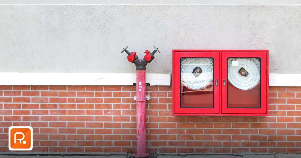 Fire Fighting Equipment Suppliers UAE: 2026 Civil Defence Procurement Guide - outdoor fire hydrant and hoses against a brick