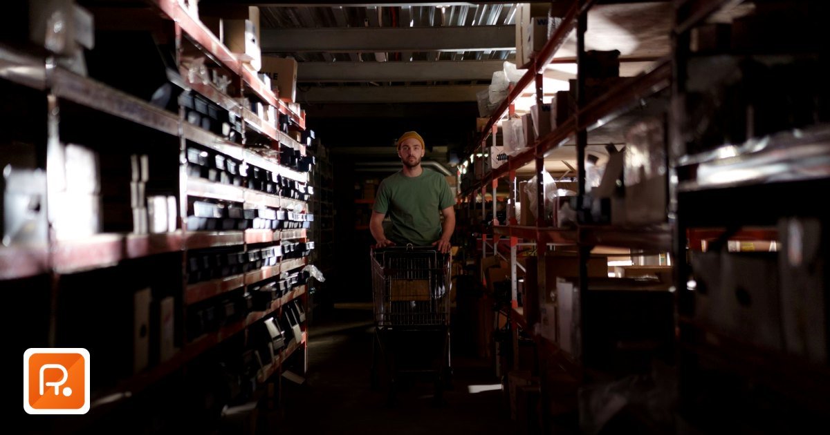HORECA Supplies Wholesale in the UAE: B2B Procurement Guide 2026 - a man wearing a beanie pushes a cart through a dimly lit