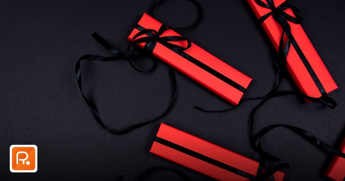 VAT Corporate Gift Procurement Dubai: A Free Zone Guide - top view of red gift boxes with black ribbons on a dark background