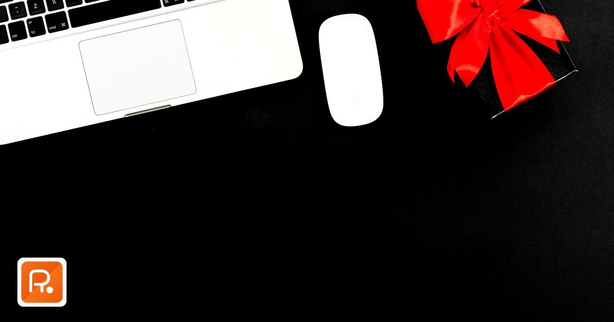 VAT Corporate Gift Purchases UAE: A Practical Guide for B2B Buyers - flat lay of laptop and gift box with red bow on black