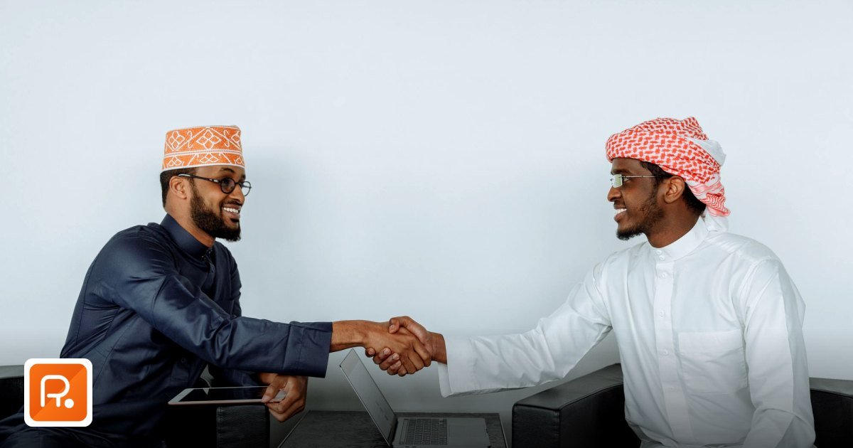 Payment Terms with UAE Wholesale Suppliers: What's Normal - two businessmen in traditional attire shaking hands in a modern